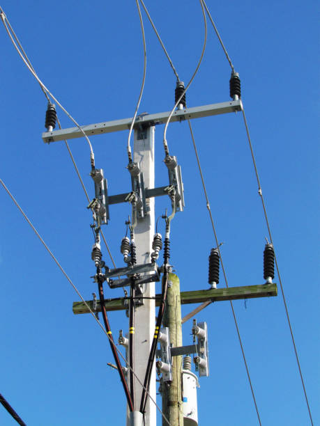 Crew preparing foundation for lighting pole at construction site.