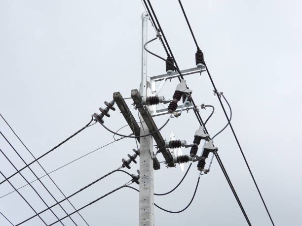 Skilled pole setter positioning lighting pole with precision in Florida.